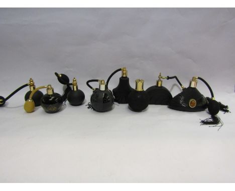Eight black glass and ceramic perfume bottles including cabochon and gilt design examples