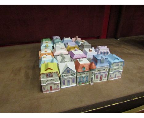 A set of 24 Brooks &amp; Bentley 1991 lidded spice jars in the form of houses with display shelf