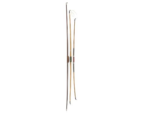 AN EARLY LAMINATED BOW AND TWO PRESENTATION LONGBOWS, 19TH/20TH CENTURY the first constructed of four laminations of wood, in