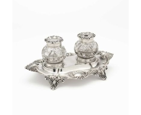 A VICTORIAN SILVER INKSTAND, HENRY WILKINSON & CO., SHEFFIELD, 1851 shaped oval, the leafy rim with matted details and two ca
