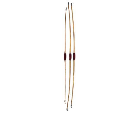 TWO AYST AND ONE PURLE LONGBOW, LATE 19TH/EARLY 20TH CENTURY the first by Ayst and of hickory, 22# draw weight, horn nocks an