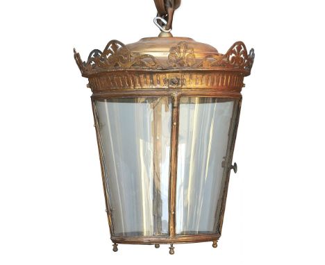 A bronzed metal and glazed circular hall lantern, late 19th/early 20th century, of tapered form, with pierced, scrolled and f