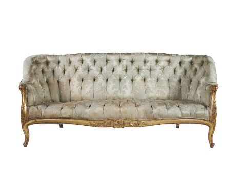 A Victorian giltwood sofa, circa 1870, in French taste, the button upholstered back and integral arms above a conforming seat