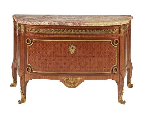 ϒA French kingwood, marquetry inlaid, and gilt metal mounted commode in Louis XVI style, of bowfront outline, the marble top 