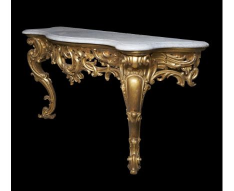 A carved giltwood console table, 19th century, with a serpentine moulded white marble top above a pierced frieze carved with 