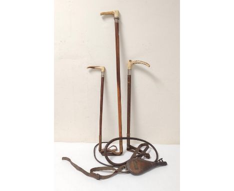 Three riding crops with antler grips circa early 20th century, one example with button badge for makers Armstrong & Co of Car