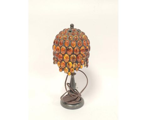 Tiffany style table lamp, the shade with overall inset amber beads, on knopped stem and circular foot, 33cm high. 