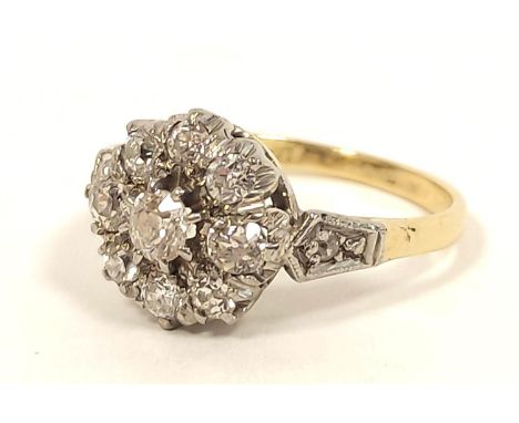 Diamond nine stone cluster ring in gold '18ct platinum' 1930's. Size 'K½'. 3.4gCondition report:Good condition with solid cla