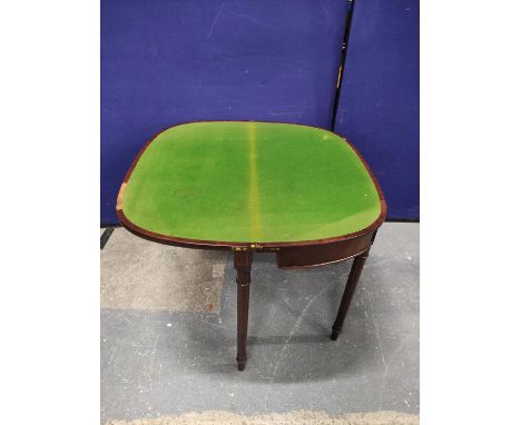 Early 19th century mahogany card table of almost semi-circular shape with tulipwood crossbanding upon tapering ring turned ci