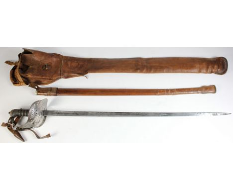 Sword: An 1897 Pattern Infantry Officers sword by Henry Wilkinson SN:- 60296. In its leather field service scabbard. Etched b