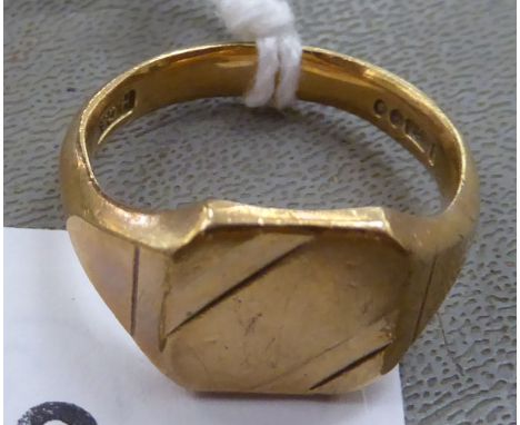 A 9ct gold signet ring with a textures shank 