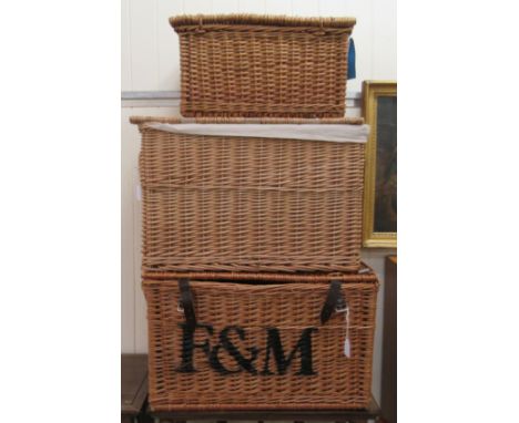 A Fortnum &amp; Mason woven cane hamper&nbsp; 24"w; another, similar&nbsp; 22"w; and a picnic hamper&nbsp; 19"w 
