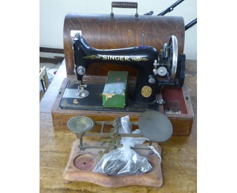 Edwardian brass balance scales with tablet weights, on an incurved mahogany platform; and a vintage Singer manual sewing mach
