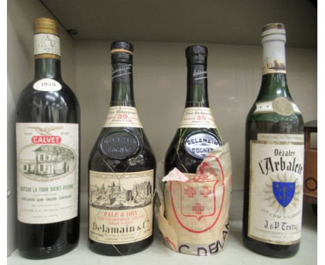 Two bottles of Delmaine Cognac; a bottle of Chateau de la Tour Saint-Pierre 1959; and a bottle of Swiss Dezaley L'Arbalete 