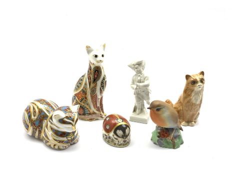 Berlin white glazed porcelain figure ice skating on square base H11cm, three Crown Derby paperweights with silver stoppers, R