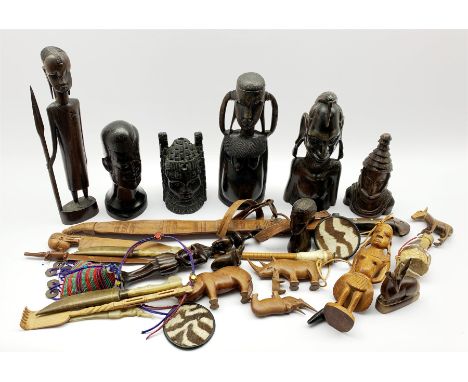  Number of African carved wood tribal figures, African sword in leather scabbard and other African itemsClick here to view fu