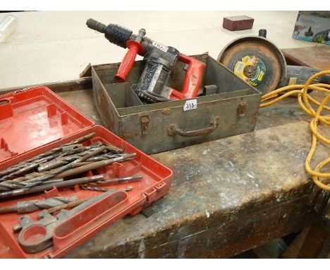 A Hilti TE17 and a Black and Decker 9" grinder, both 110V and a box of masonry drill bits.