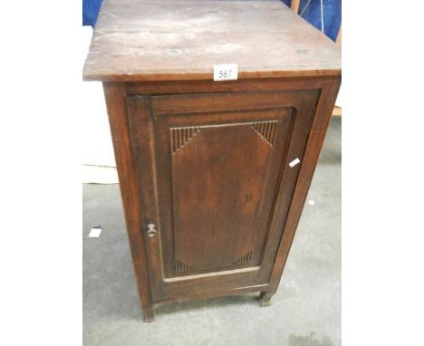 A 1920's oak cupboard with inner shelf.