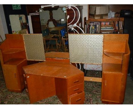 A 1960's light mahogany head board with side cabinets and a corner dressing table.