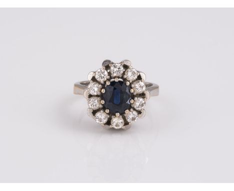 EDELSTEIN RING WG 750. Ringmaß ca. 50. Ges.-Gew.: ca. 7,3 g. Ein oval facettierter Saphir, ca. 1.45 ct; 10 Brillanten, zus. c