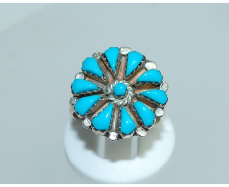 A sterling silver ring with turquoise flower decoration. Size M. Weight 3.9g