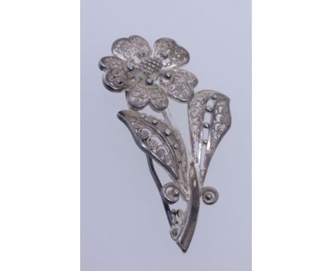 A vintage sterling silver filigree brooch in the form of a flower with roller clasp. Marked 925 Sterling Foreign with further