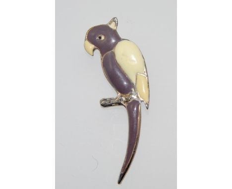 A 1950s yellow metal and enamel parrot brooch with fixed safety pin style clasp . Measures 6cms.