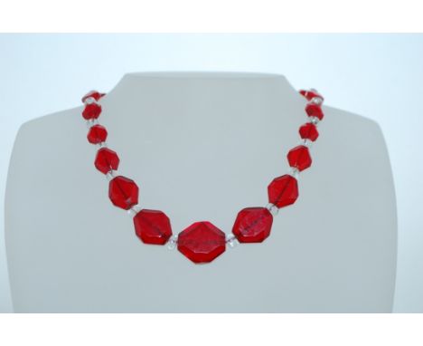 A 1930s Art Deco Czech glass bead necklace with faceted red and button cut clear glass beads with gem set clip clasp. Marked 