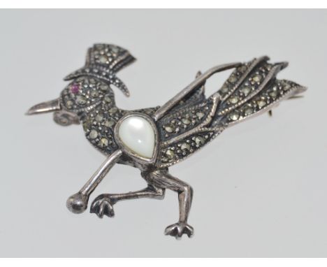 A vintage 925 silver marcasite brooch in the form of a crow with a red stone eye wearing a top hat holding a  moonstone set c