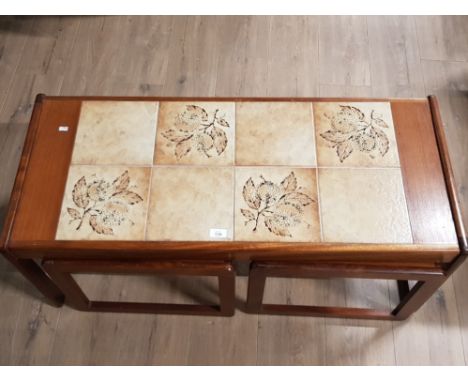 A RETRO TEAK AND CERAMIC TILE NEST OF TABLES BY SUNELM 105 X 42.5 X 46CM