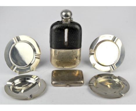 Set of four ash trays, London 1960, leather cased spirit flask with silver cup, Sheffield 1910 and a cigarette case, Chester 