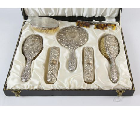 Modern embossed silver brush set including hand mirror, two clothes brushes, and two hair brushes, Birmingham 1964/1965 a non