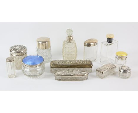 Two engine turned silver and enamel topped dressing table jars and a collection of other silver topped dressing table jars an