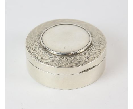 Round form silver table box with hinged lid with engine turned and starburst decoration, 151 grams, Birmingham 1946.