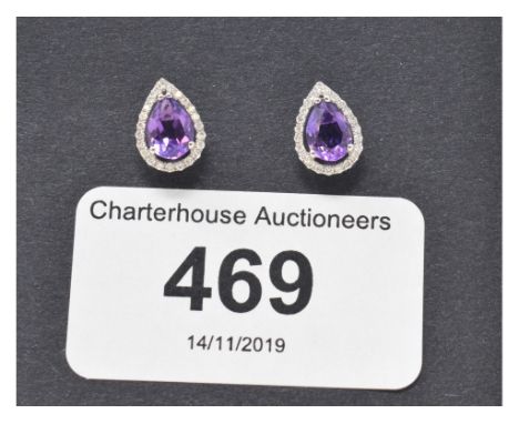 A pair of 18ct white gold, pear shaped amethyst and diamond stud earrings 