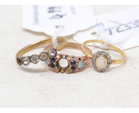 EXTRA LOT: A gold coloured metal, opal and diamond ring, and two other rings (3) 