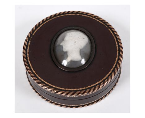 A 19th century tortoiseshell snuff box, inlaid with gold, the cover applied an oval head study of a gentleman, 8 cm diameter 