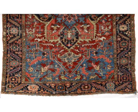A Caucasian carpet, with geometric motifs within a multi border, worn and cut, 346 x 260 cm See illustrationReport by GHNear 