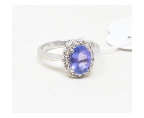 A white coloured metal, tanzanite and diamond cluster ring, approx. ring size L, unmarked 