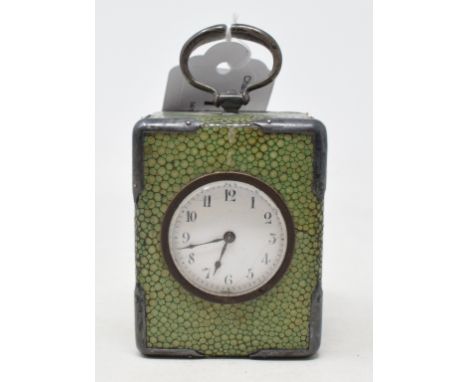 A travelling timepiece, the 3 cm enamel dial with Arabic numerals, in a shagreen mounted case, with a carrying handle, 9 cm h
