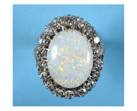 An 18ct gold ring, set an oval opal within a surround of eighteen diamonds, approx. ring size M See colour illustration 