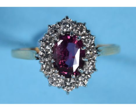 An 18ct gold ring, set a ruby within a surround of twelve diamonds, approx. ring size T½ See illustration 