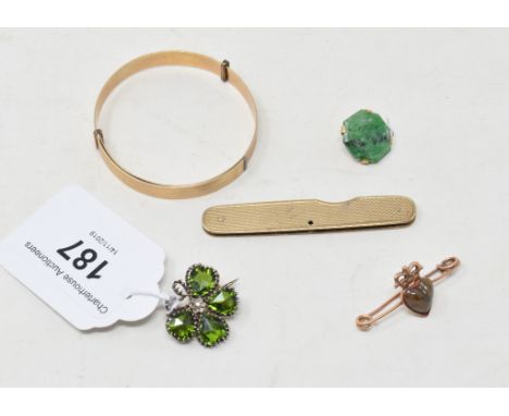 A rolled gold child's bangle, a 9ct gold mounted pen knife, two brooches, and a jade button 