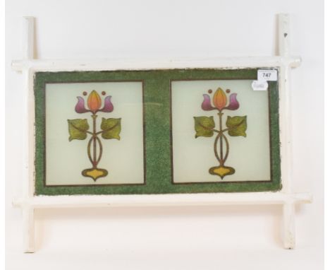 An Art Nouveau bubble glass panel, decorated two stylised flowering plants, 57 cm wide 