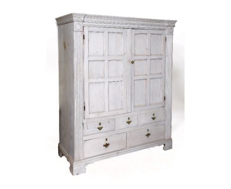 A painted pine housekeepers type cabinet, having a pair of panel doors above three short and two long drawers, flanked by ree