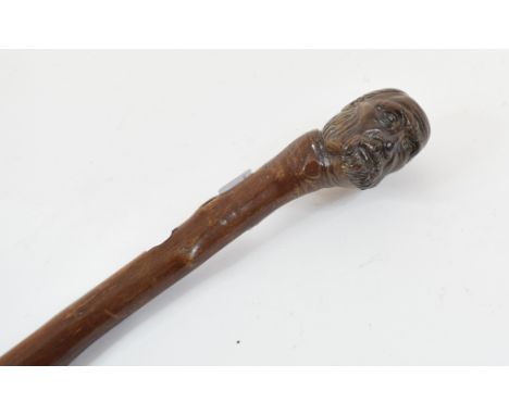 A folk art walking cane, the handle in the form of the head of a Victorian gentleman, 87 cm 