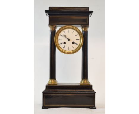 A late 19th century French portico clock, with 9.5 cm diameter enamel dial with Roman numerals, fitted an eight day movement,