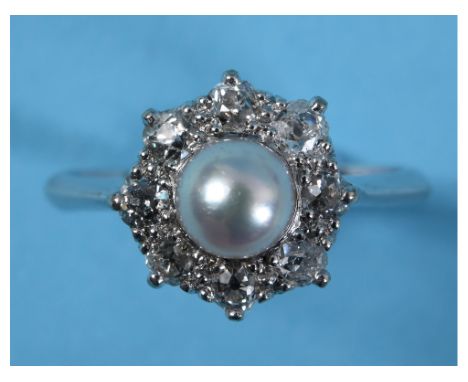 An 18ct gold and platinum ring, set a pearl within a surround of eight diamonds, approx. ring size N  See illustrationReport 