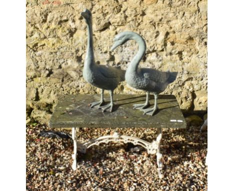 A garden table, 91.5 cm wide, two metal garden geese and a pair of table supports (5) 
