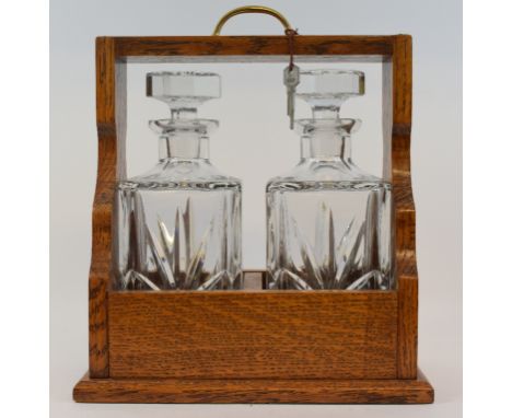 A two division oak Tantalus, 28 cm wide, a Dendy Sadler coloured print, fishermen, and a presentation wall barometer, in a ti